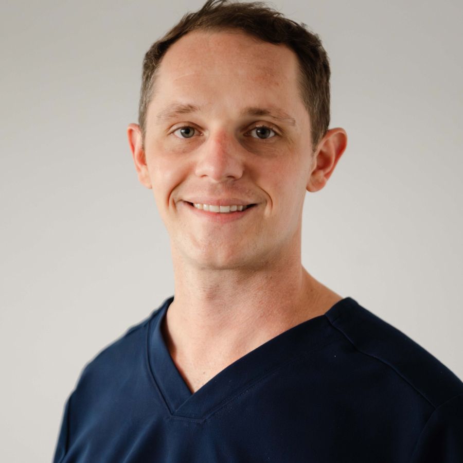 madison dentist dr paul wehner smiling in his blue scrubs